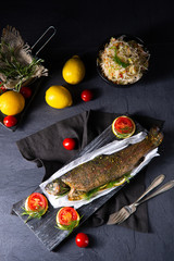 baked trout with herb filling and tomatoes