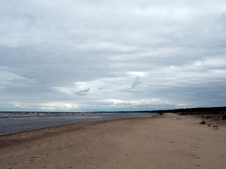 A cool, windy beach in the fall. Cloudy sky. Without people.
