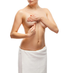 Fototapeta premium Woman examining her breast isolated on white background