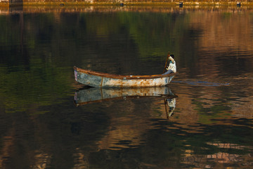 Lonely old rusty boat on the lake