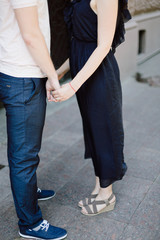 the guy and the girl hold each other by hands 