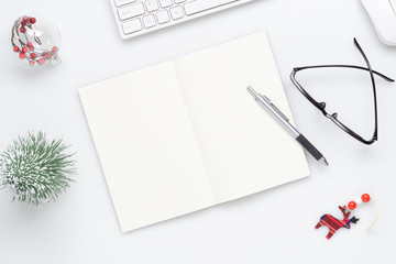 Christmas mockup background with blank space notebook, Christmas ornament decorations on white table. Space for text. Top view. Christmas to do list or wish list.