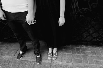 the guy and the girl hold each other by hands