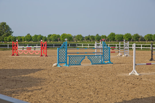 Image of show jumping poles on the training field. Wooden barriers for jumping horses as a background. Horse agility track with jump obstacles for equestrian sports .
