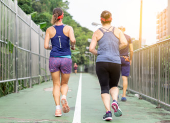 Blurred background of people walking and running at park outdoor.