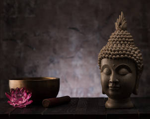Buddha head statue and singing bowl