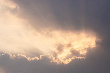 Fototapeta na wymiar Golden sunlight ray shining throught dark clouds.