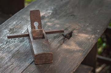 Old carpentry planer, vintage wood planer, on a wooden table.