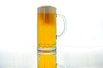 Light beer in a glass goblet on a white background