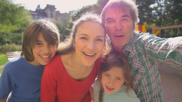 Happy family taking selfie in park