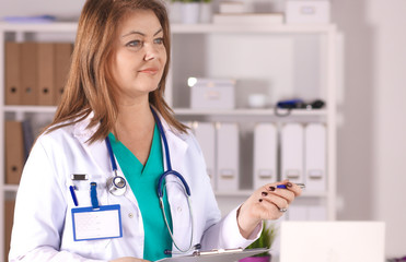 Portrait of happy medical doctor woman in office