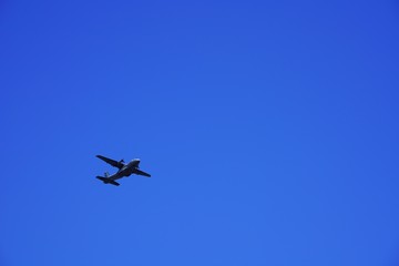 military cargo transport airplane in the clear blue sky