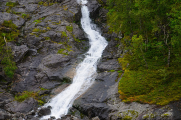 Gigantic beautiful waterfall in the Norwegian mountains. Scenic and moody.