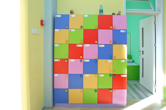 strong rows of color lockers in kindergarden, school, dressing room in pool, children room with texture in white circles .