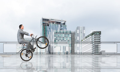 Man riding bicycle on penthouse balcony