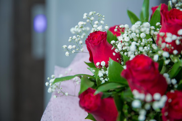 Bouquet of red roses on a dark and white wooden background. Top view . Bouquet of red rose.