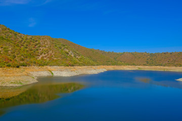 Fototapeta na wymiar Dam with low level of water in the south of Spain