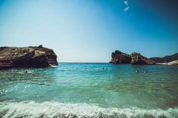 Adriatic coast in summer. The height of the tourist season. Transparent warm sea and mountains. Montenegro.