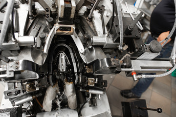 Man use special machine tool for making a shoes. The conveyor on a shoes factory with shoe and...