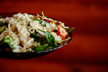 salad with cheese, chicken, spinach, tomato