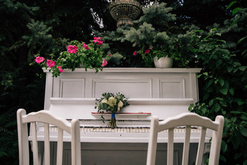 bride's wedding bouquet on a white piano