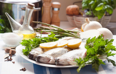 trout with lemon and onion lying on the plate
