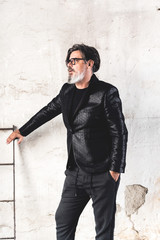 Obraz premium Portrait of mature handsome male model who posing in old abbandoned hall