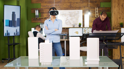 Female architects exploring virtual reality project of business buildings