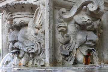 Two-person sculpture, water pouring from the mouth