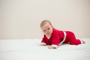 Beautiful little baby celebrates Christmas. New Year's holidays. Baby in a Christmas costume