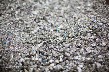 Pieces of ferrotitanium closeup. Ferroalloy used for alloying, deoxidation and degassing of steels and alloys