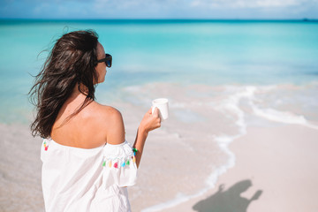 Young woman with cup of hot coffee enjoy holidays