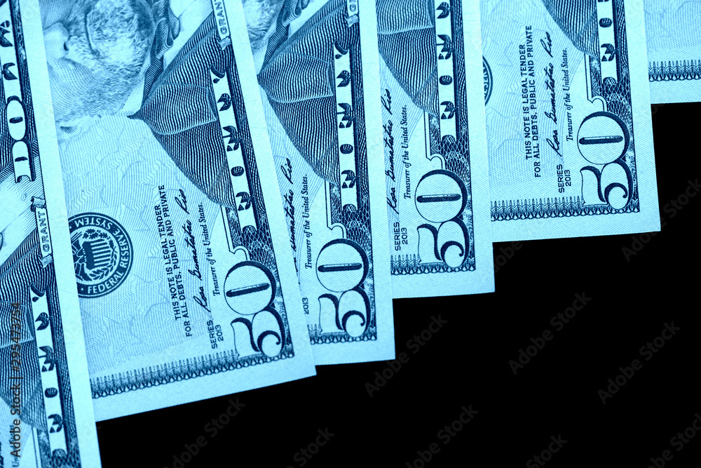 Wall mural fifty dollars banknotes isolated on black background close-up. blue color toning