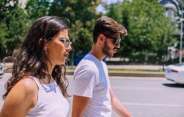 Young couple walking together while enjoying a day in the park