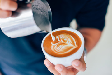 Coffee latte art in cafe - obrazy, fototapety, plakaty