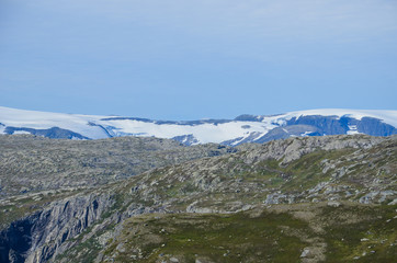 Landscape photo of the trail path to the cliff Trolltunga in the Norwegian mountains.