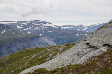 Fototapeta na wymiar Landscape photo of the trail path to the cliff Trolltunga in the Norwegian mountains.