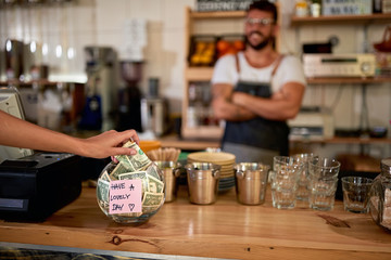 Coffee business concept.Tips jar - satisfied customer
