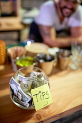 Obraz na płótnie Canvas Tips - Money left for a employee, concept.