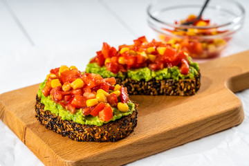 Avocado And Sweetcorn Salad On Toast With Tomatoes
