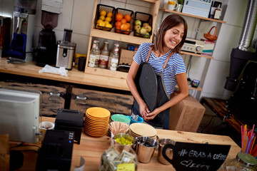 Young cafe woman standing at bar in cafe store- Woman barista