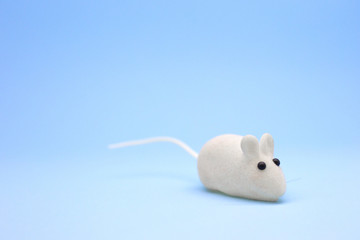 New year. White toy mouse on a blue background. White rat. Symbol of the year 2020. Place for text