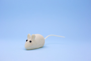 New year. White toy mouse on a blue background. White rat. Symbol of the year 2020. Place for text