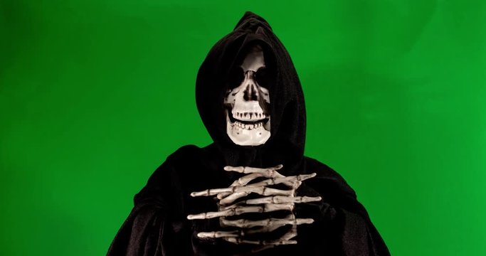 Talking skeleton with black scarf stop motion footage on a green background.