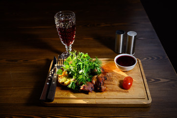 Sliced meat. Grilled beef steak on wooden cutting board. Grilled meat.