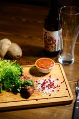 Sliced meat. Grilled beef steak on wooden cutting board. Grilled meat.