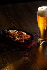 Fried prawns with fresh rosmarin and lemon juice and a glass of beer