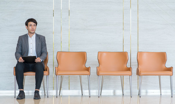 Asian business people are stressed about waiting for a job interview.