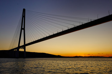Fototapeta na wymiar The silhouette of the cable-stayed bridge in Vladivostok, a beautiful view of the sunset