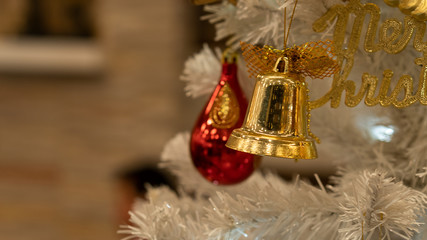 Golden bells ornaments hanging on the christmas tree
